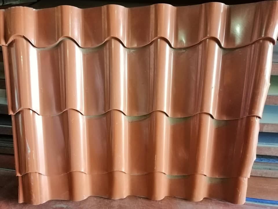 Close-up of terracotta-colored tile-profile roofing sheets