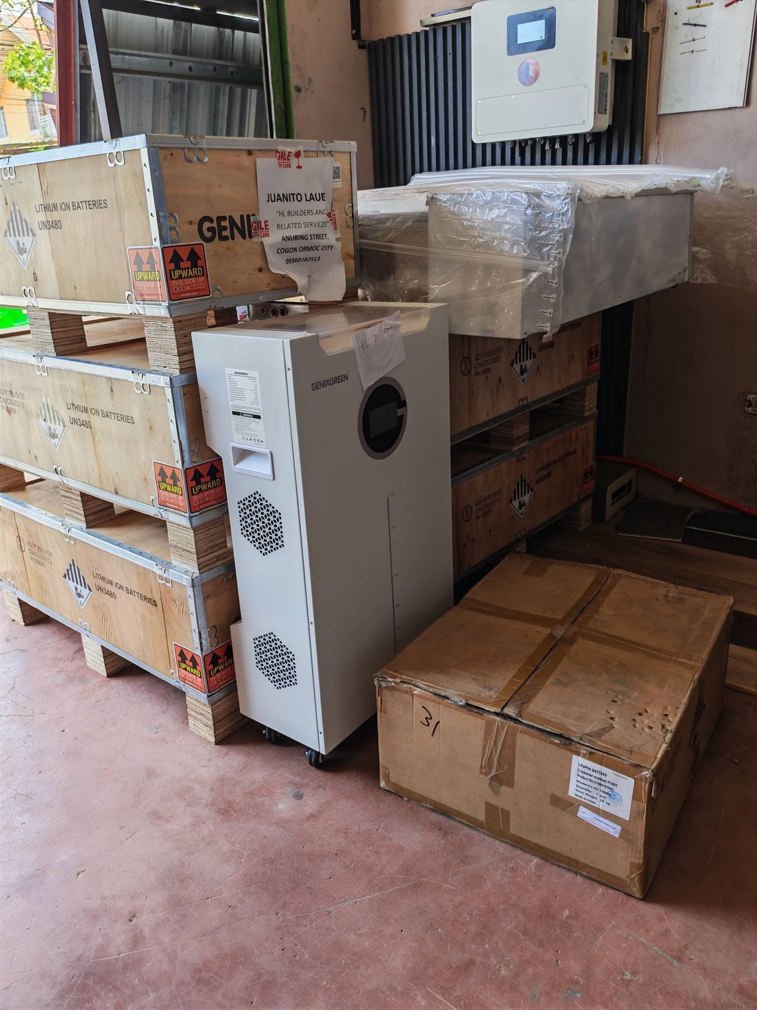 Genixgreen LiFePO4 battery, hybrid inverter and crates of lithium batteries in the HL Bars warehouse